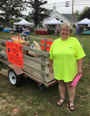 Donna Gregory stands next to the cart set up for donations to the Lincoln County Animal Shelter. KELLIE BIGOS/Boothbay Register