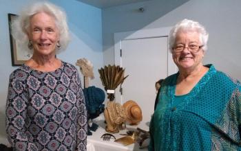 Cheri Kavanagh, left, and Katharine Martin-Savage, both of Wiscasset, view historical clothing. JANE CARPENTER/Boothbay Register