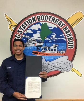 Fireman Elijah L. Wattree is shown with his citation after being named the “Sailor of the Quarter.” That honor is voted on by the station personnel and bestowed on the Coast Guard member who distinguishes himself through exemplary service and dedication. Photo by Bruce MacCormac, Coast Guard Auxiliary