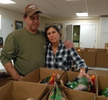 Abbe Levin and Ronny Arsenault help fill Thanksgiving dinner boxes. JANE CARPENTER/Boothbay Register