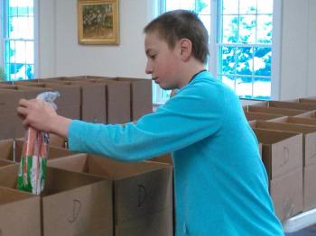 Carrots are added to a Thanksgiving dinner box. JANE CARPENTER/Boothbay Register