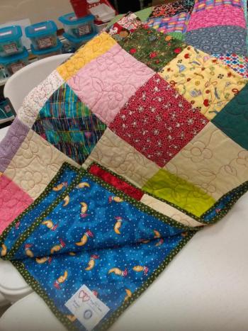 A stack of quilts destined for the Rotary’s wrap a smile program waits at the Community Center. JANE CARPENTER/Boothbay Register
