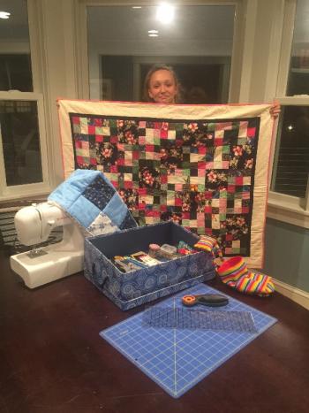Teal Beavis shows the completed quilt with her original design. Courtesy of Angel Ames
