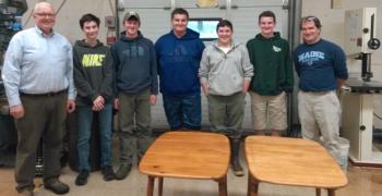 The five BRHS students who refinished tables for the Community Center stand behind their work. From left are Community Center board president Shawn Lewin, Zach Brewer, Jake Kelley, Jordan Carrier, Riley Faulkingham, Matthew Sullivan and STEM teacher Chip Schwehm. JANE CARPENTER/Boothbay Register