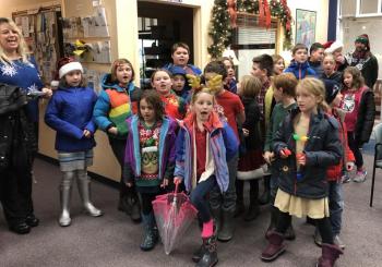 A traveling chorus from Southport Central School sang for the Community Center Dec. 21. Meredith Fowlie, guidance and cultural studies teacher, is at the left. Courtesy of Jen Field