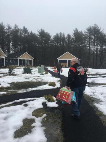Daren Graves, foreground, and Reid Hodgdon, background, deliver Rotary’s Christmas gift bags to veterans. Courtesy of Charlee Noble