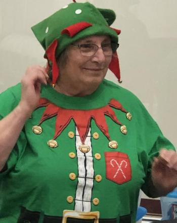 Community Center volunteer Connie Heroy donned her best elf apparel to welcome pre-school singers from Lighthouse Learning Center at the Community Center on Dec. 13. Courtesy of Jen Field