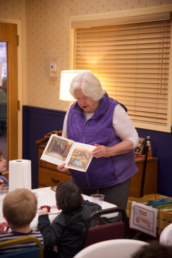 Margaret Perritt, Community Center board member, reads a Christmas story to pre-schoolers from Lighthouse Learning Center. Bob Crink photo