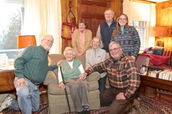 Jean Thompson holds Southport’s Boston Post Cane, presented to her by the town’s selectmen (all kneeling, from left), Smith Climo, Mary Lou Koskela (Jean’s daughter) and Gerry Gamage. Looking on are Jean’s other daughter, Anne Maher, son-in-law Phil Koskela and granddaughter, Carrie Koskela. Robert Mitchell photo
