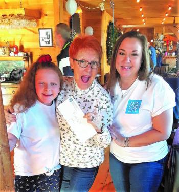 This is one enthusiastic raffle recipient with Suzie Edwards, left, and Kyndall Schmidt. STEVE EDWARDS/Boothbay Register