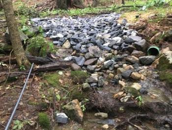 The after photo shows a stone ford built using Clean Water Grant funds at the crossing, This allowed stream water to move across the road through the rocks and allowed vehicles passage over the road. Courtesy photo