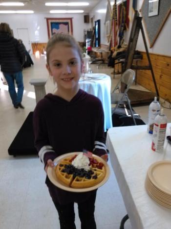 And a flag on top! Allison Smart with a breakfast waffle. JANE CARPENTER/Boothbay Register
