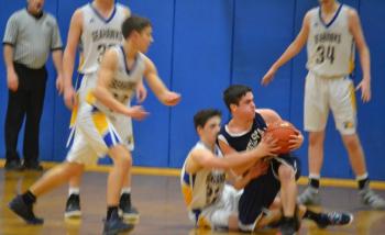 Senior Brett Hollowell battles for a loose ball Feb, 6 in the Seahawks' final regular season game. BILL PEARSON/Boothbay Register