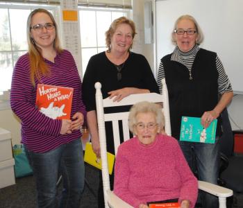 Three generations: Jean Thompson in rocker with, from left, granddaughter Carrie Koskela, and daughters Anne Maher and Marylou Koskela at Southport Central School March 1. Courtesy of Eileen Higgins
