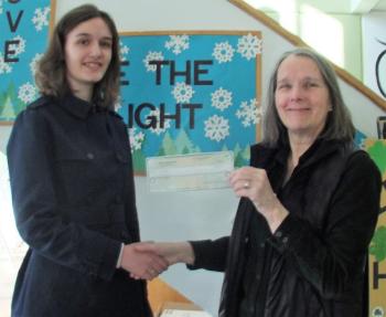 Friends of WJD member Rosemary Bourette presents BRES eighth grade student Grace Campbell with a check for $250 - the cash prize for the winning T-shirt design in the first ever design contest. LISA KRISTOFF/Boothbay Register
