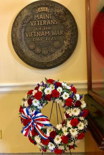The ceremonial red, white and blue wreath beneath the Maine Vietnam War Plaque in the Hall of Flags. Sarah Sherman photo