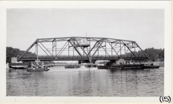 The swing span is drifted into place. Courtesy of MDOT historic bridge archives