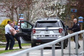 Konstantinos Rigas puts up a struggle before being placed in the police car. JOSEPH CHARPENTIER/Boothbay Register