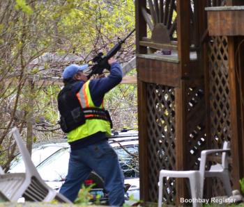 Boothbay Harbor reserve police officer Nick Upham with gun drawn during the standoff. JOSEPH CHARPENTIER/Boothbay Register