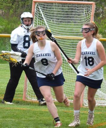 Boothbay defender Hannah Cola, left, moves up field May 29 in her team’s 15-12 loss to undefeated Winslow at Sherman Field. BILL PEARSON/Boothbay Register