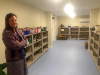 Stephanie McSherry in one area of the huge downstairs library at The Merry Barn of Edgecomb. LISA KRISTOFF/Boothbay Register