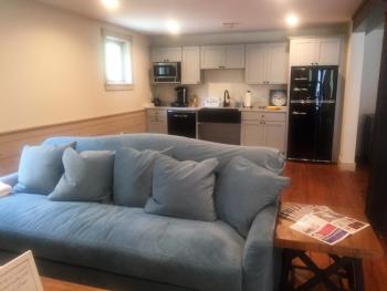 One of the two comfy blue sofas and the kitchen beyond on the main floor. LISA KRISTOFF/Boothbay Register