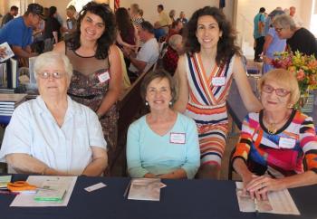 Boothbay Harbor Memorial Library representatives welcomed 35 Maine authors July 27 to Boothbay Railway Village. Pictured, sitting, from left, event volunteers Sharon Pulkinen, Cheryl Blaydon,Gloria Taliana. Standing, from left, Library Executive Director Joanna Breen, and Assistant Director Desiree Scorcia. BILL PEARSON/Boothbay Register