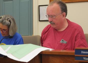 Planning board member Bruce Bowler reviews Ray Egan’s plans for a timber harvest. Egan submitted his plan’s as a requirement of his participation in the Maine Tree Growth program. BILL PEARSON/Boothbay Register