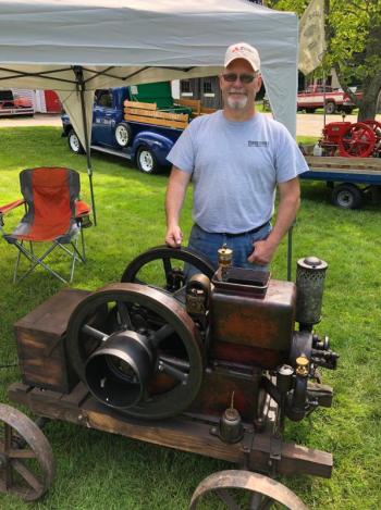 Rick Gilbert of Augusta stands with a 2.5-horsepower International engine he recently bought. CRAIG LANCASTER/Boothbay Register Railway Village, engines, mechanics, Maine Antique Power Association