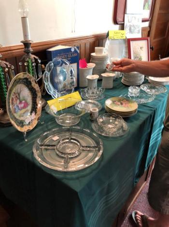 A fair attendee looks at antique dishware at Southport Country Fair. CRAIG LANCASTER/Boothbay Register Southport, Southport Country Fair, Southport Town Hall, Southport United Methodist Church