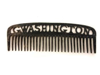 A rare example iron comb with hollow cut lettering along the handle that reads “G. Washington,”