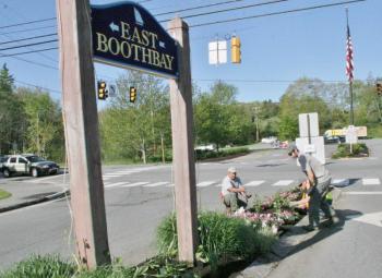 A scene from a 2014 story on the traffic island beautification. The posts and sign are the ones destroyed this past February. File photo