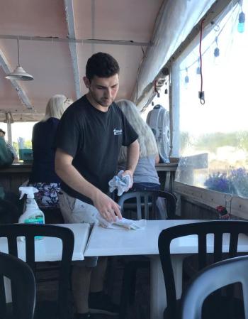 Ilker Yerlikaya buses tables. KELLIE BIGOS/Boothbay Register