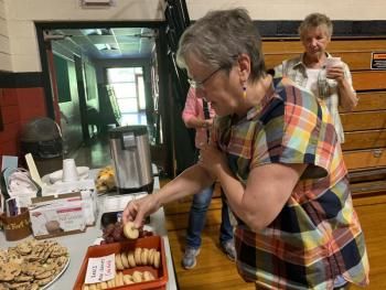 Judy Flanagan of Wiscasset chooses a snack at the bicentennial lecture. SUSAN JOHNS/Wiscasset Newspaper