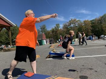 The First National Bank’s Jean Moffatt throws a practice bag at at a cornhole tournament at Ames True Value Supply Sept. 22 to benefit the masons’ Lincoln Lodge in Wiscasset. SUSAN JOHNS/Wiscasset Newspaper