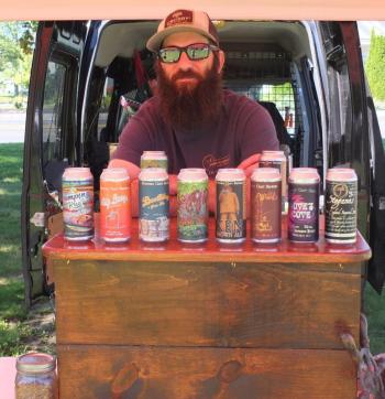 Chris Harris of Boothbay Craft Brewery promotes local brews Sept. 5 during the Boothbay Farmers’ Market. BILL PEARSON/Boothbay Register