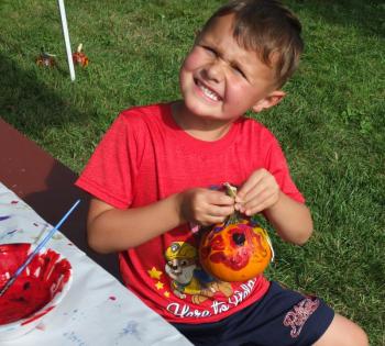 Oscar Ortiz of Brunswick displays his painted mini-pumpkin Sept. 22 at Family Harvest Days. BILL PEARSON/Boothbay Register