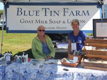 Penny Theall, left, and Crystal Lewis sell organic pork and goat’s milk soap and hand lotion Sept. 5 during the Boothbay Farmers’ Market. BILL PEARSON/Boothbay Register
