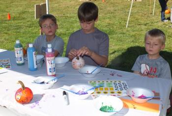 Pumpkin painting was a popular activity on Sept. 21 and 22 during Family Harvest Days. From left, Miles, Cole and Eli Hyson were among dozens of kids who received a free pumpkin to paint or carve at Boothbay Railway Village. BILL PEARSON/Boothbay Register