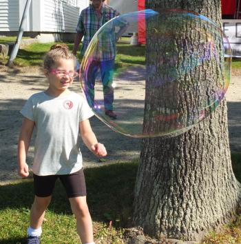 This Family Harvest Days guest checks out a huge bubble during the Sept. 21 and 22 event. BILL PEARSON/Boothbay Register