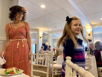 Natalie Dunbar takes a fashionable spin as she and grandmother Sherri Dunbar, left, volunteer as models at a Lincoln County Historical Association fundraiser Oct. 5. SUSAN JOHNS/Wiscasset Newspaper