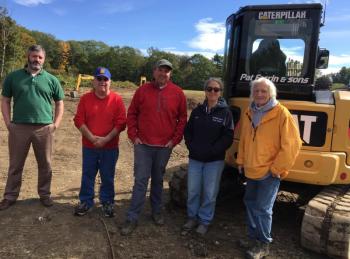 A community effort began last week to prepare Clifford Park for future expansion. Pat Farrin, and his crew began leveling off a back field at the park. Pictured, from left, are Boothbay Town Manager Dan Bryer, Tommy Nickerson, Kipp Farrin, Boothbay Region Water District Watershed Protection Manager Sue Mello, and Pat Farrin. BILL PEARSON/Boothbay Register