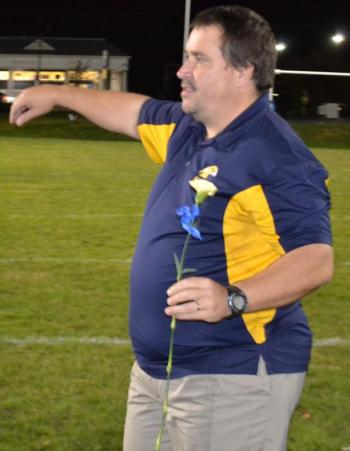 Coach Ed Crocker presented carnations to his 10 graduating BRHS seniors before the last regular football season home game. BILL PEARSON/Boothbay Register