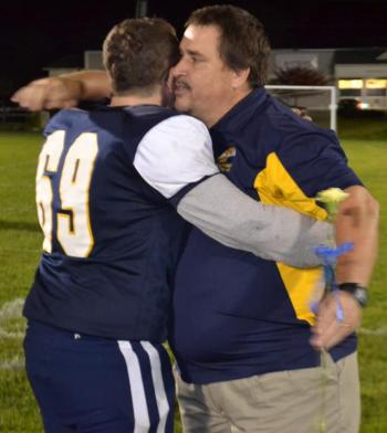 Boothbay center Dwight Lucas receives a hug from Coach Ed Crocker Oct. 11 during Seniors Night at Sherman Field. BILL PEARSON/Boothbay Register