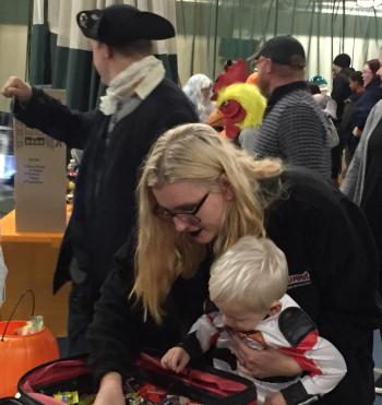 A young Trunk or Treater gets a little help finding something good. BILL PEARSON/Boothbay Register