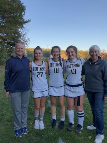 Senior Seahawk field hockey players, from left, Hali Goodwin, Chloe Arsenault and Josey Smith, gather with their coaches, Lauren Brown, left, and Donna Jordan after Tuesday’s game. Amy Goodwin photo
