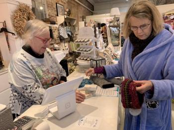 Margot Stiassni-Sieracki, right, checks out a headband at DebraElizabeths. At left, DebraElizabeths owner Deb Schaffer. SUSAN JOHNS/Wiscasset Newspaper