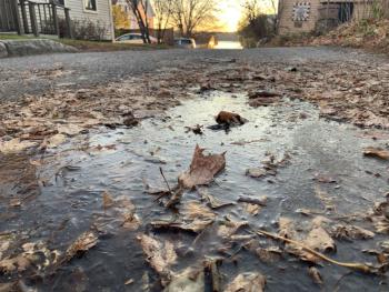 With the sun rising over the Sheepscot River in the distance, temperatures in the teens had leaves frozen in this puddle off Middle Street on Early Bird morning. SUSAN JOHNS/Wiscasset Newspaper