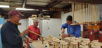 Rob Shaw, Jim Jones and Tim Hodgdon assemble lawnmowers. Courtesy of Diane Hammond
