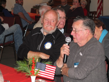 Air Force veteran Arthur Richardson, right, explains his military service as Marine veteran Sonny Webb waits his turn Nov. 7 during the local Rotary Club’s annual Veterans Day Dinner. BILL PEARSON/Boothbay Register